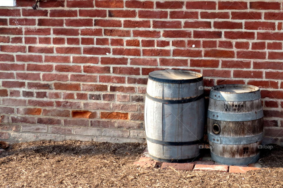 wine barrels against brick wall