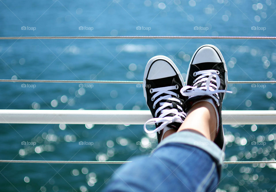 Black and white converse. Black and white converse with blue background from ocean 
