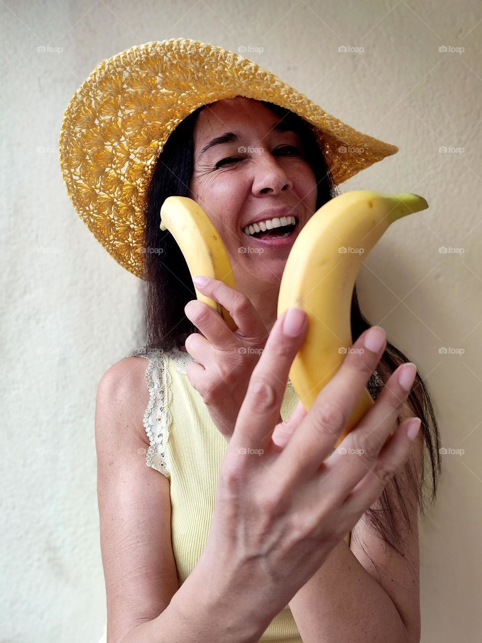 Funny Portrait of Beautiful Smiling Woman with bananas