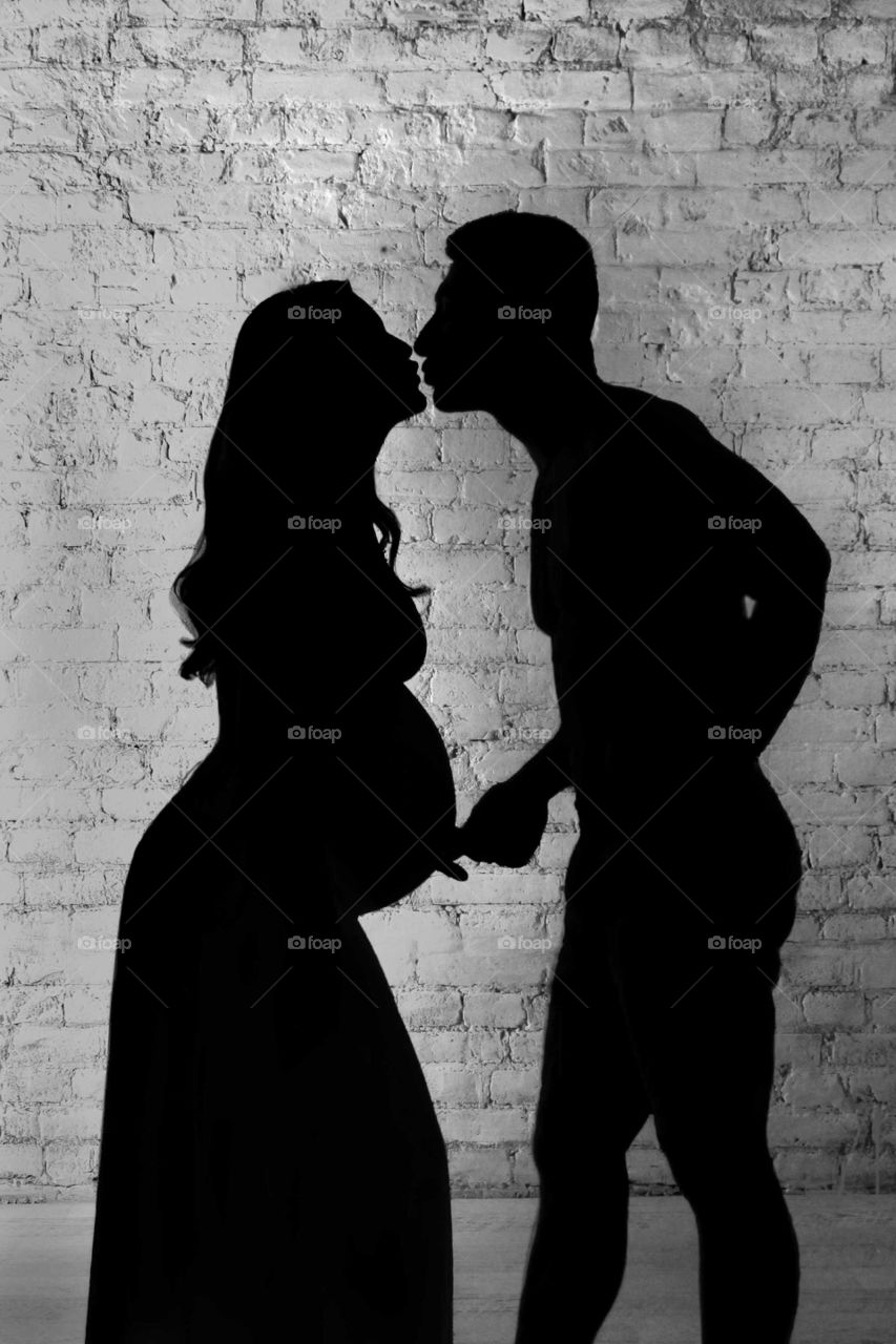 Silhouettes of kissing couple.