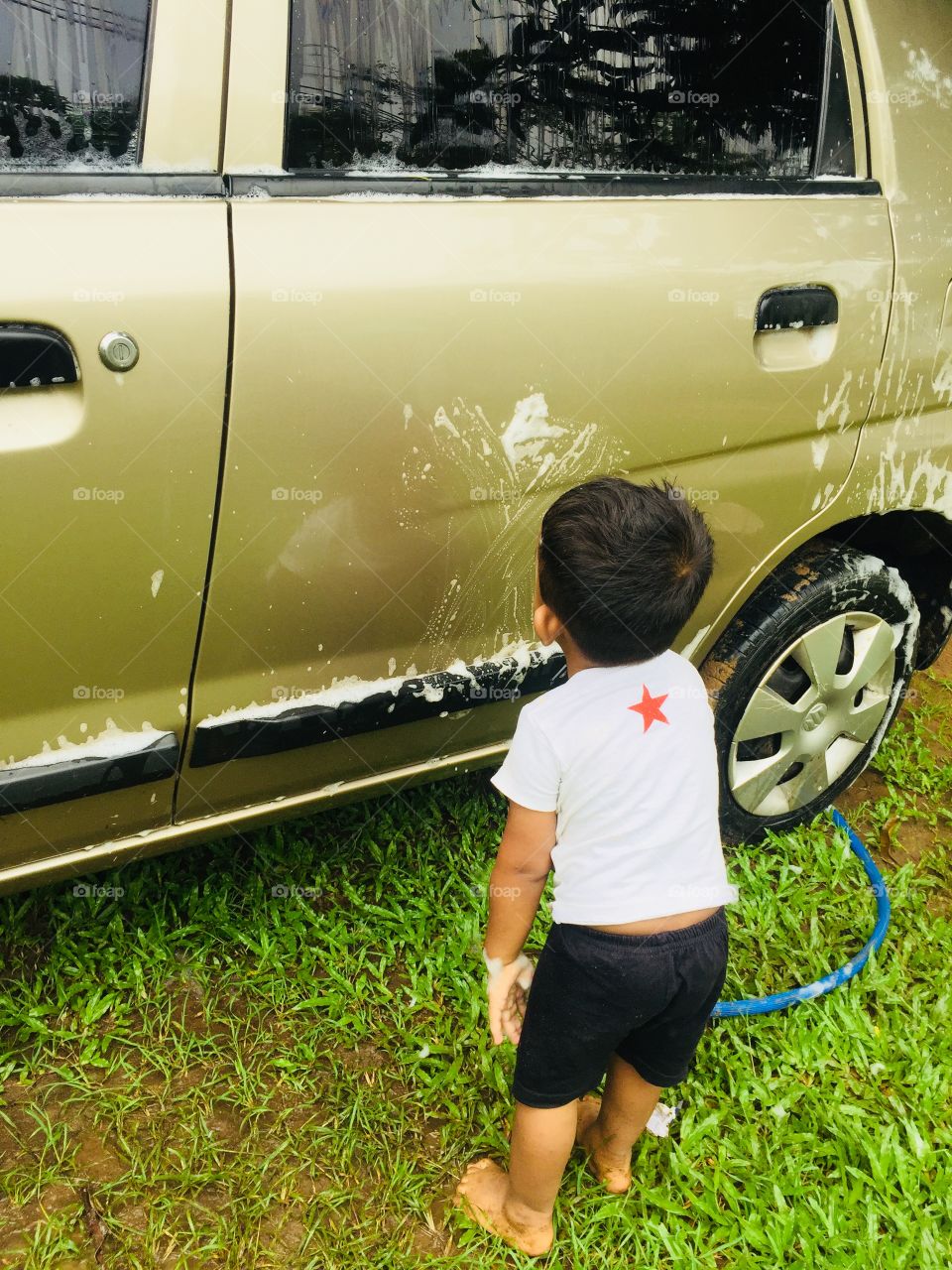 My son is washing my car ( hard working)