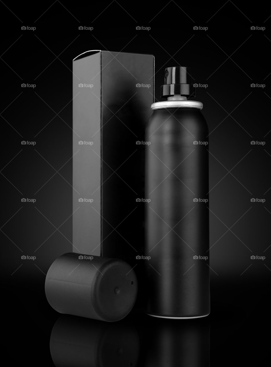 Black deodorant and box on black background