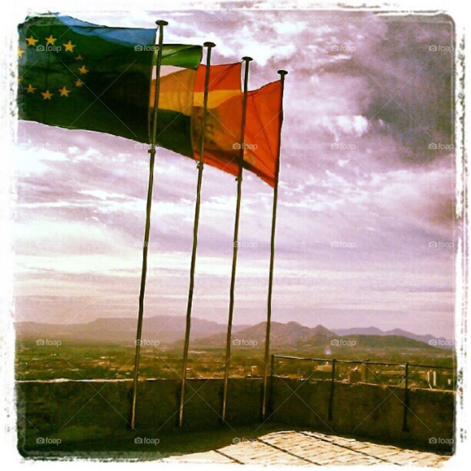 Three flags flying above the Alhambra in Spain