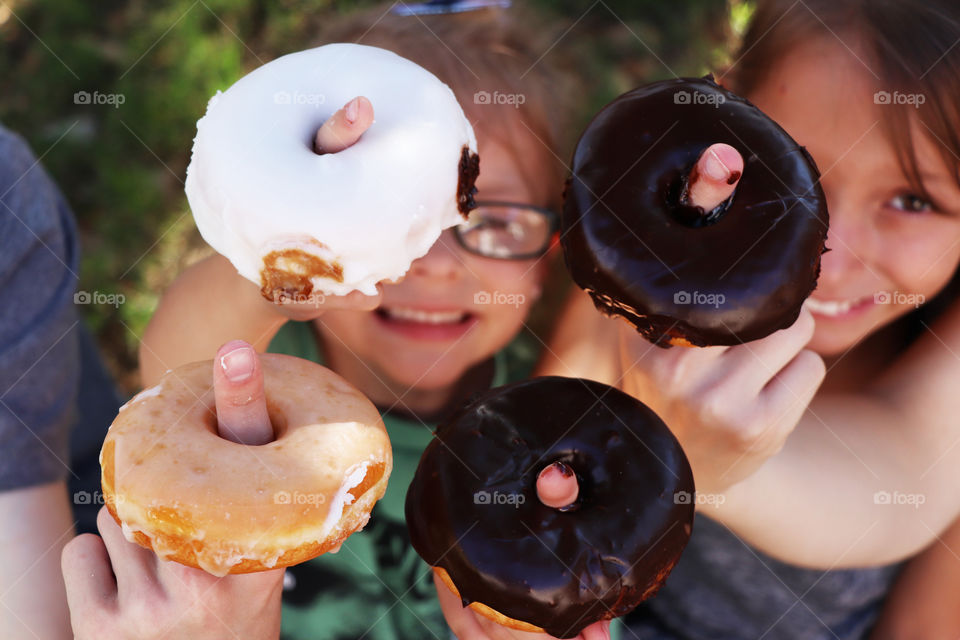 Children holding donuts