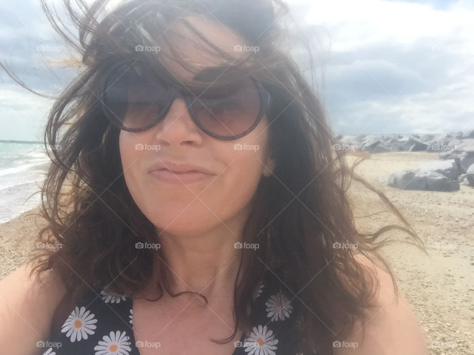 Seaside windswept selfie woman 