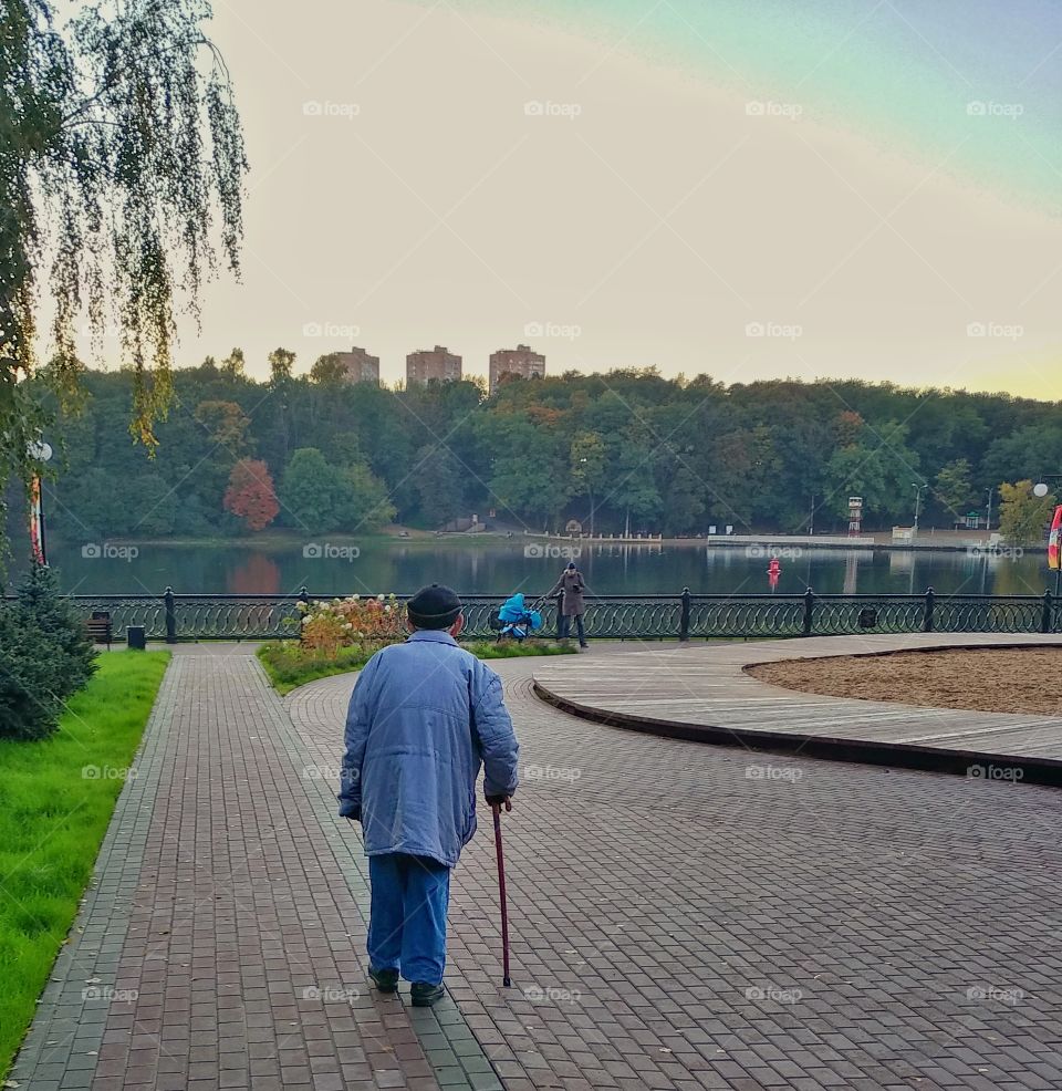 This man probably in his eighties.  It's hard fir him to walk but he wanted to get some fresh air down by the park. He was walking towards me and when I passed him by, I made this shot with my phone.