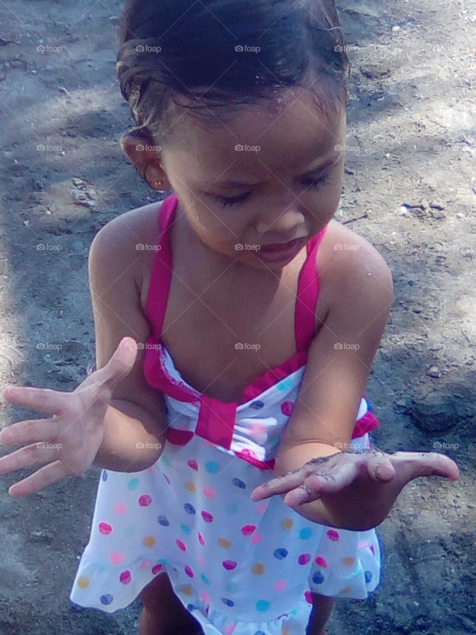 This was our daughters first visit to the beach and she was as you see, not impressed with getting her hands dirty.
