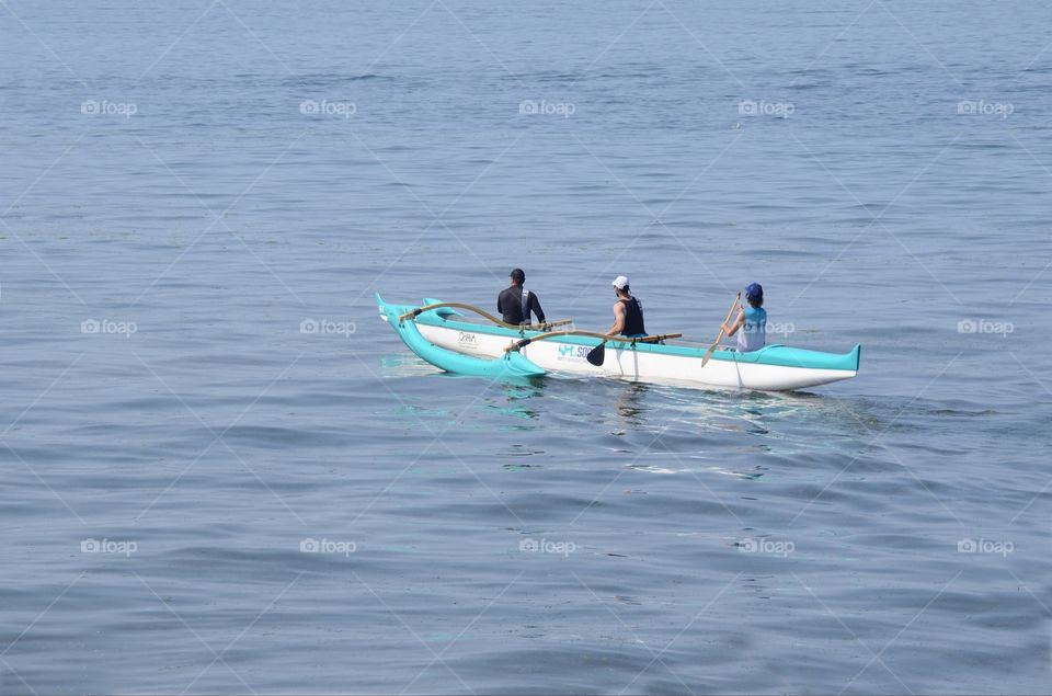 Kayakers paddle as a  team in a kayaking competition in the Puget sound of West Seattle, Washington