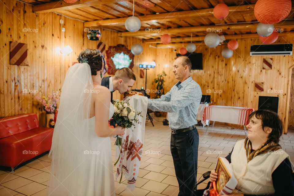 Blessing of the bride and groom with wedding bread