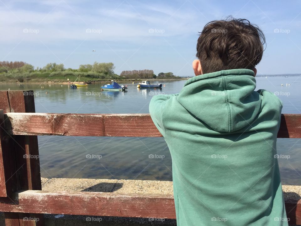 Boy looking out to sea