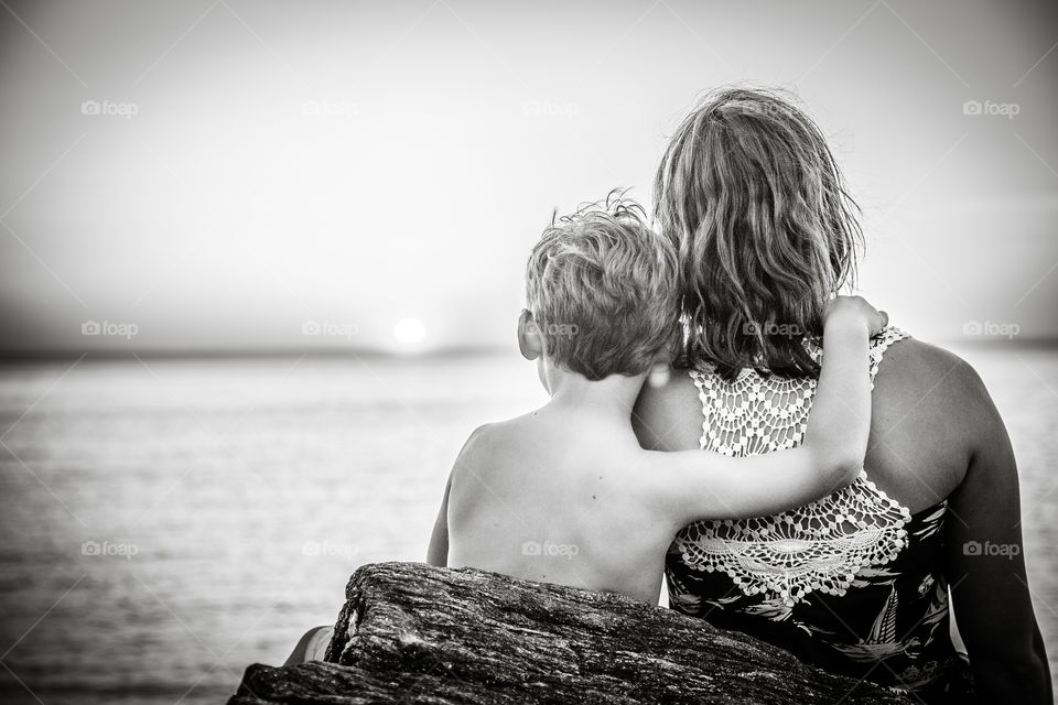 Rear view of a boy sitting with its mother