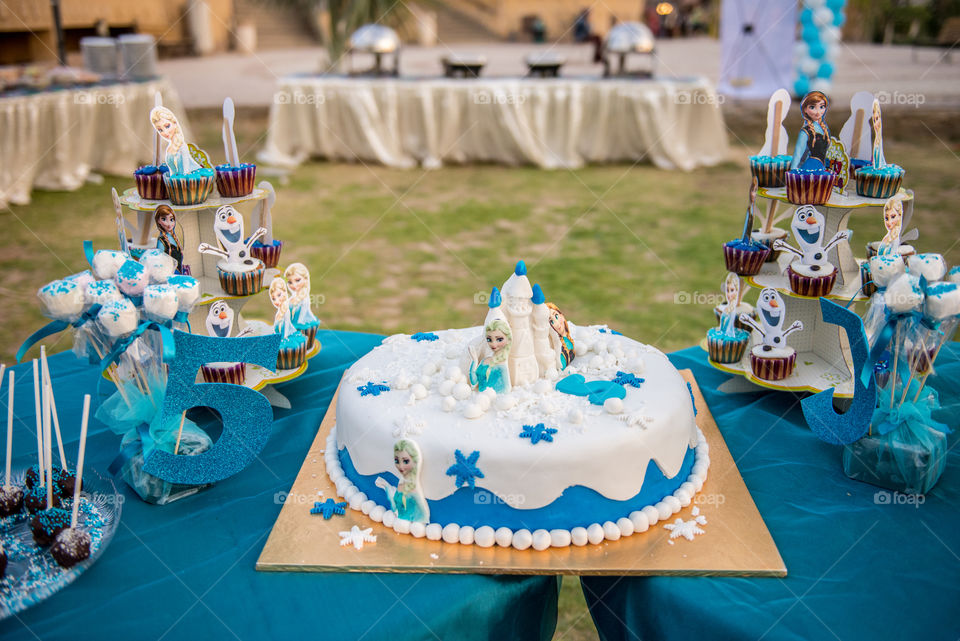 birth day cake with candies on a candyvtable of frozen theme