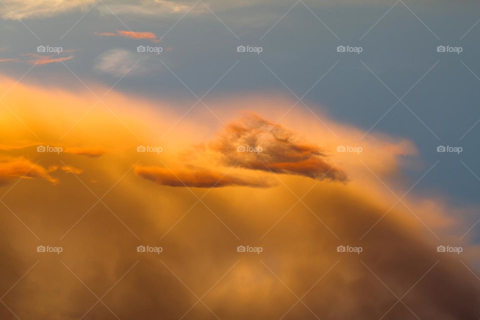 Amazing cloudy orange sky at sunset