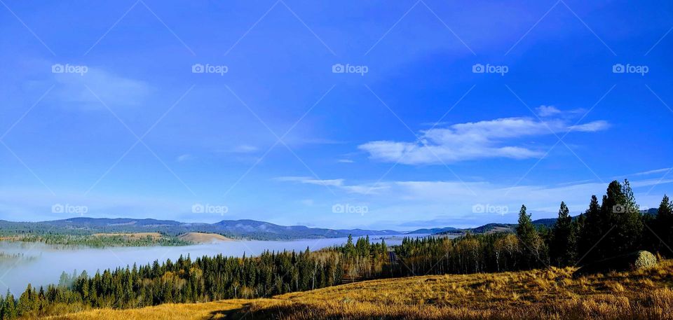 view of mountains from a distance .little road ahead zoomed in also