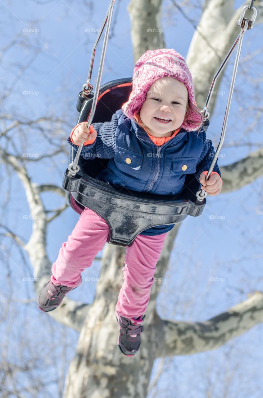 Boy playing on swing