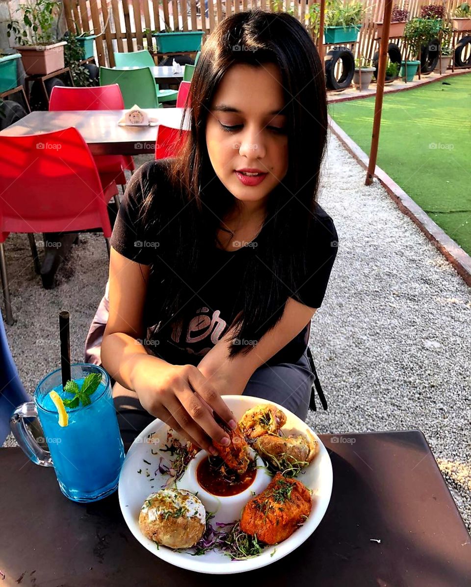 Eating Chatni with samosa