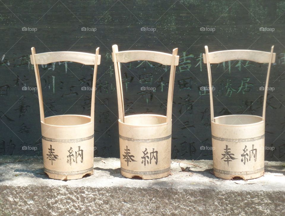 three japanese buckets on a shelf