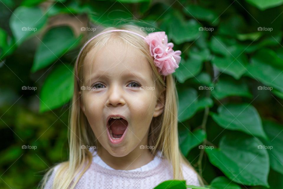 Portrait of cute Caucasian girl with surprised face