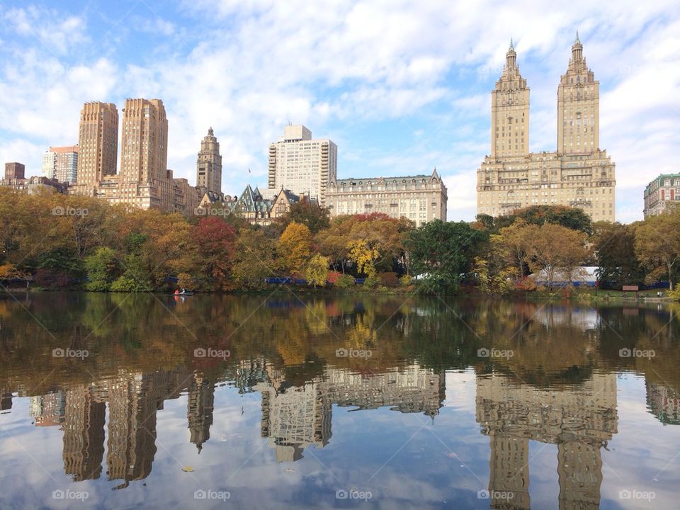 Buildings reflecting on lake, at Central Park, New York