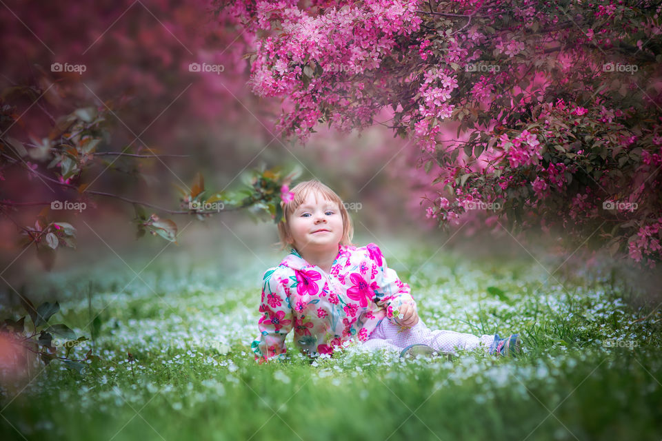 Little girl in a blossom park