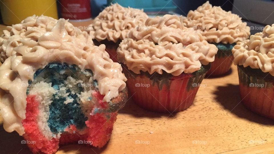 Red, white and blue cupcakes with cream cheese frosting.
