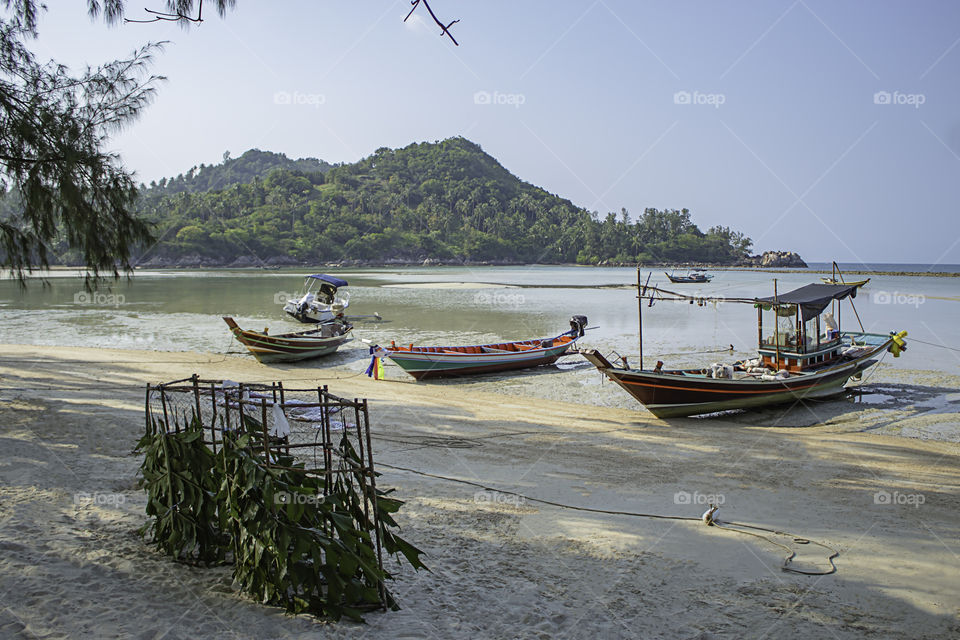 Fishing boats parked on the Beach at Koh Phangan, Surat Thani in Thailand.