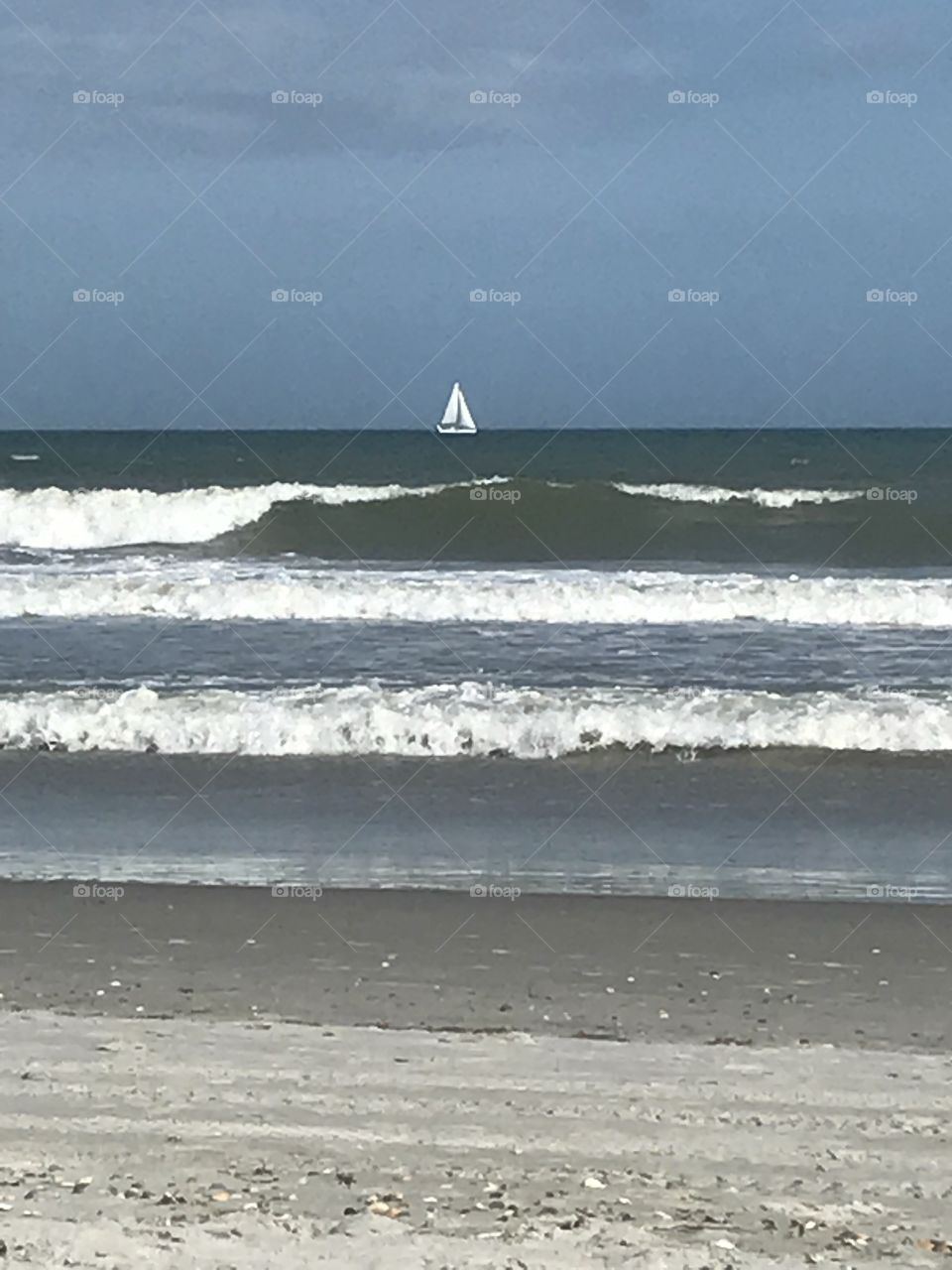 White sailboat with waves