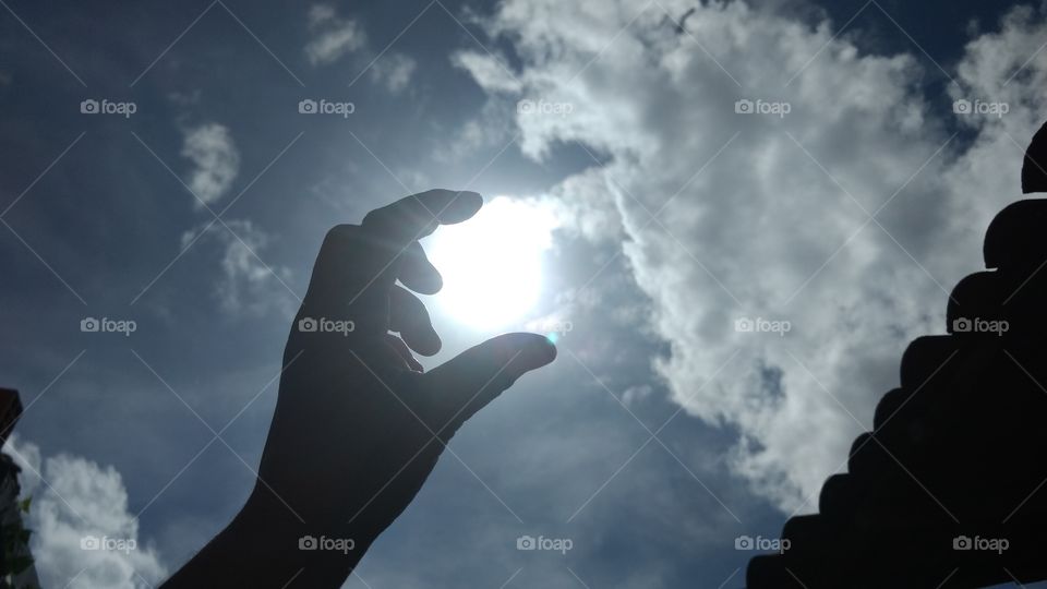 Close-up of a human hand holding sun