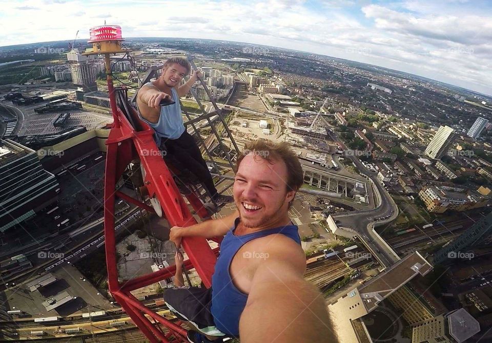 Daredevil Freerunners sitting at the very top of a crane in London