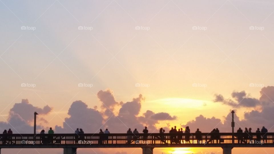 Tourist on pier during sunset