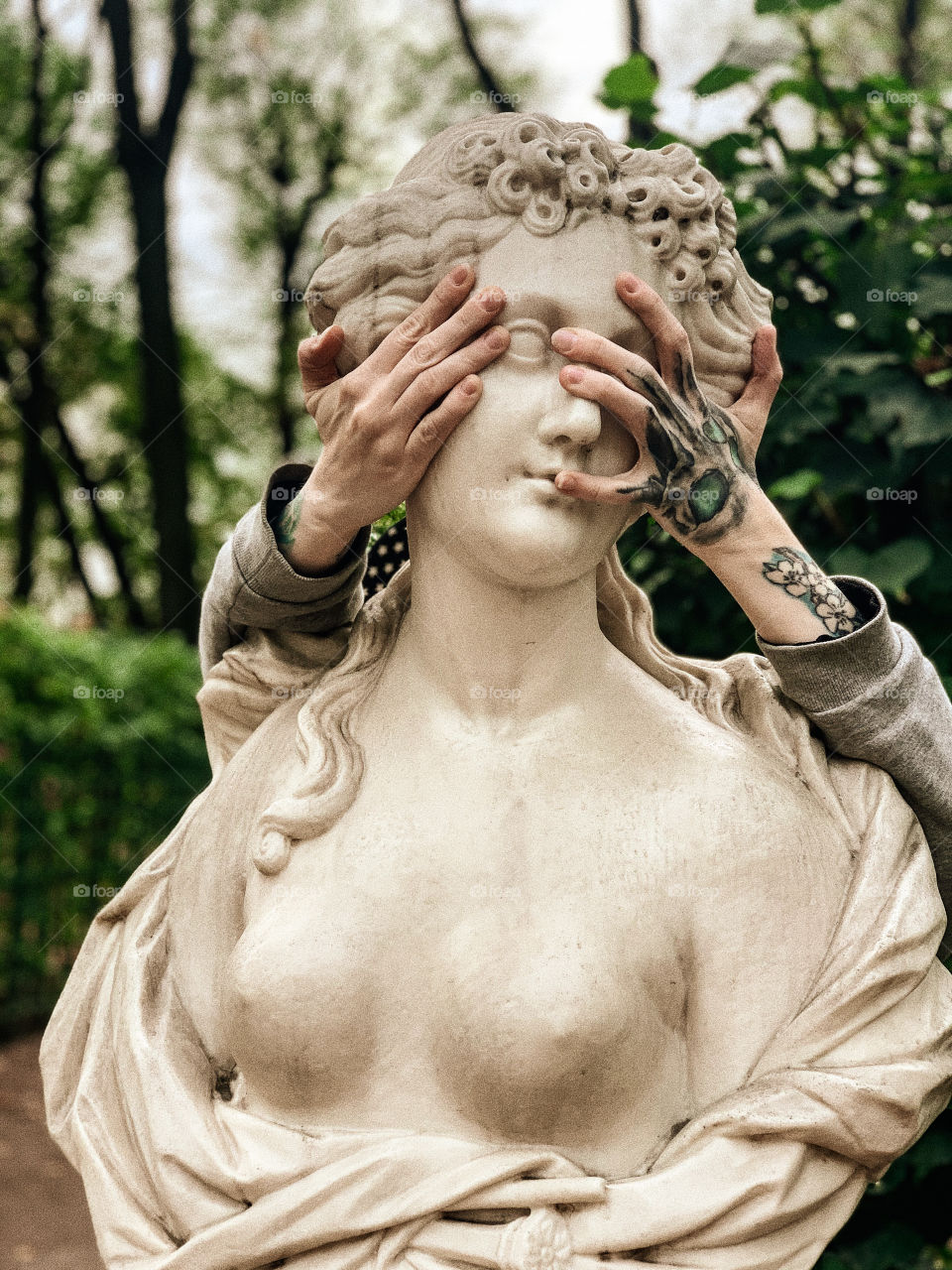 eyes closed with hands, tattoos