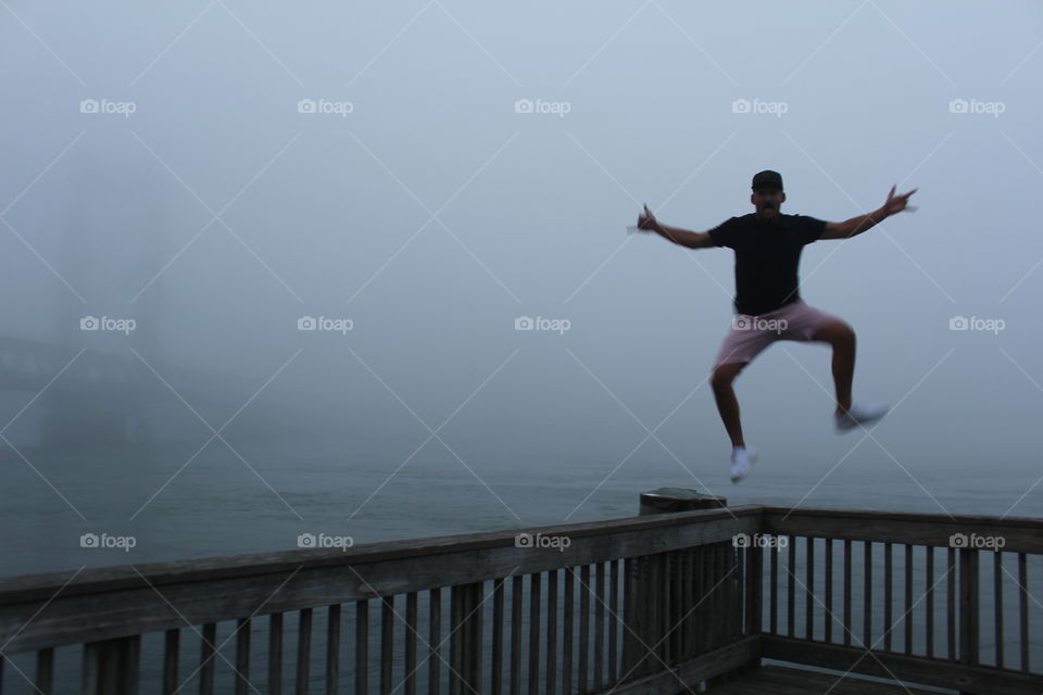 A boy with a bridge and a big jump. 