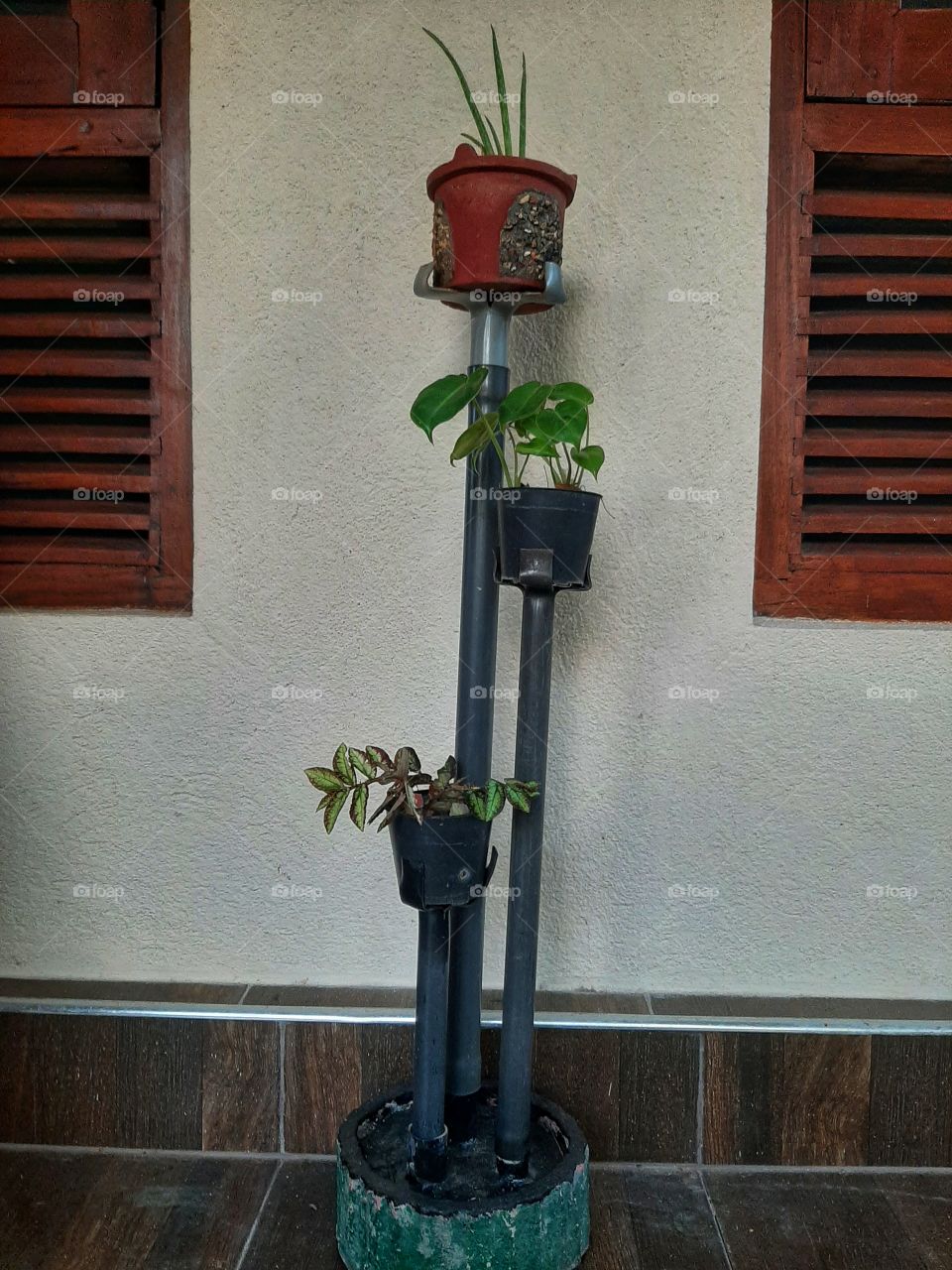 A flower pot stand is made by using PVC pipe.