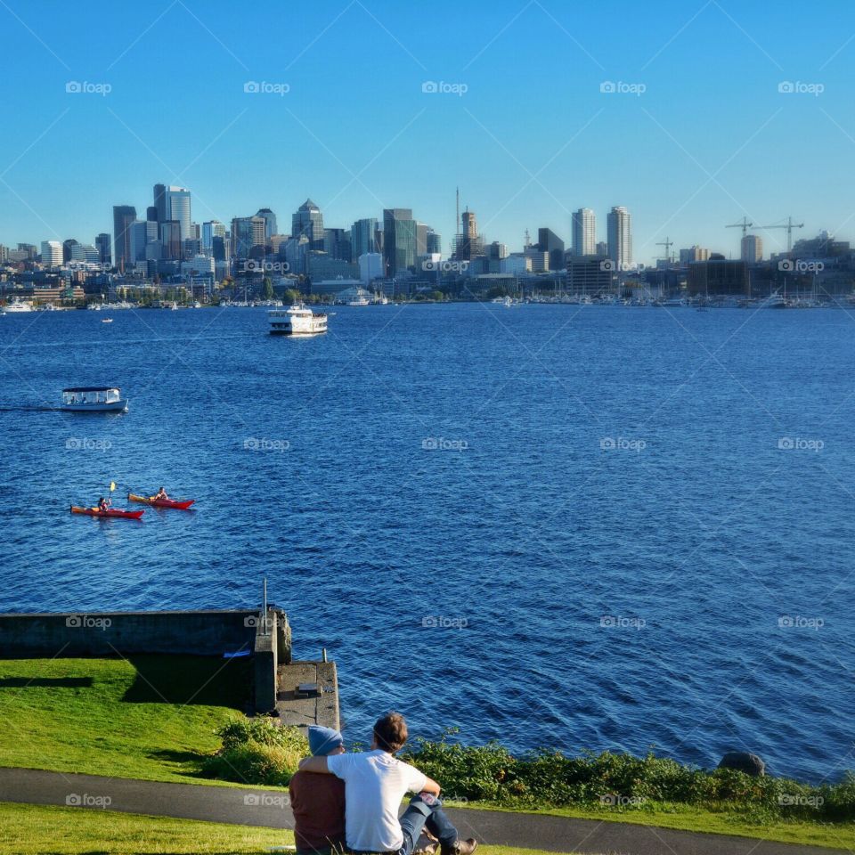 Couple relaxing in a park across from downtown Seattle