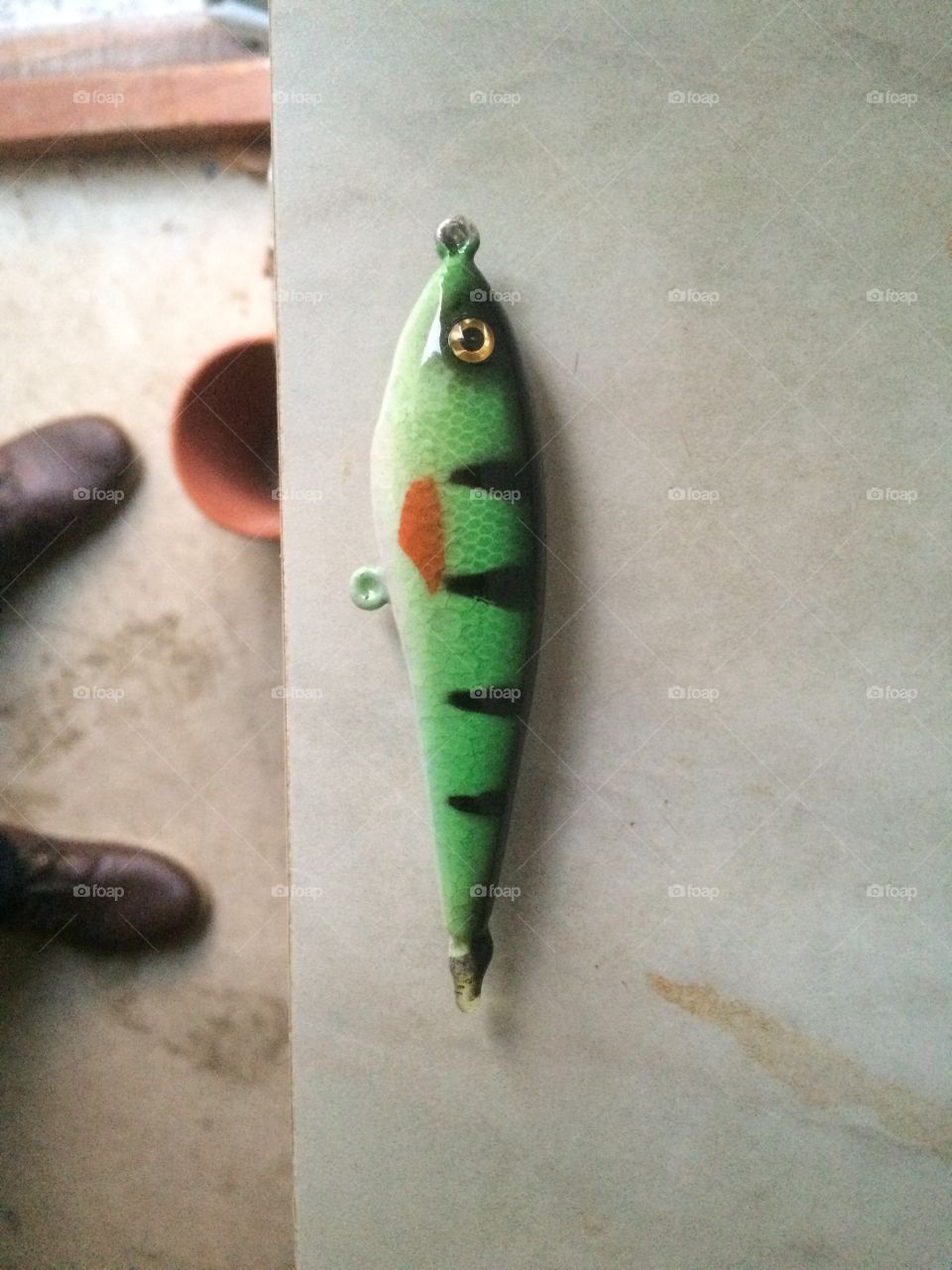 The short story: Homemade fishinglure, Carved from balsawood, sanded, drilled in wights, painted and a clearcoat finish. Ready to catch The big fish :)