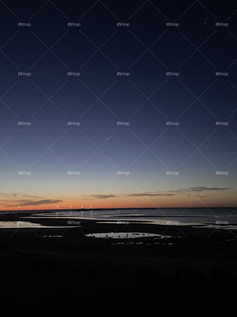 A sunset near a jetty