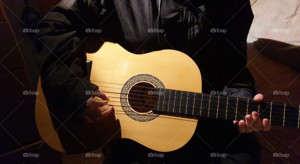 A moment in our personal space, playing the guitar, a very beautiful musical instrument and a spectacular sound