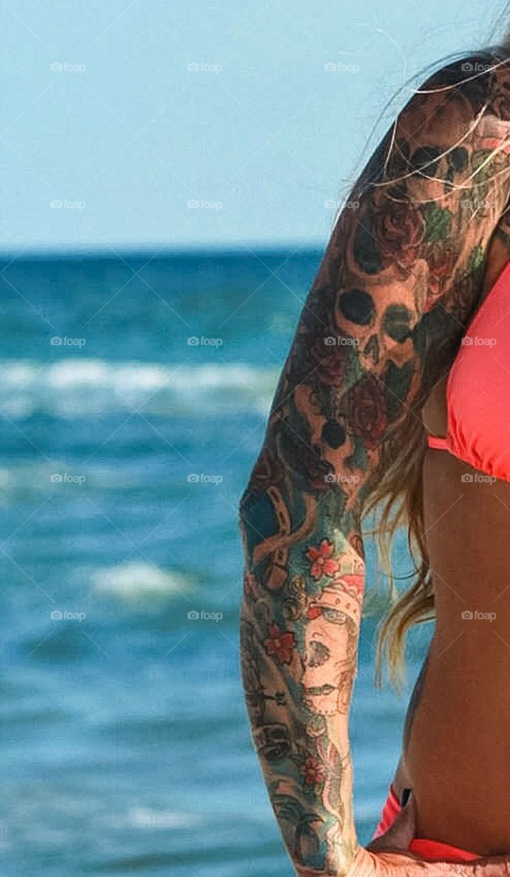 Arm tattoos & bathing suit 