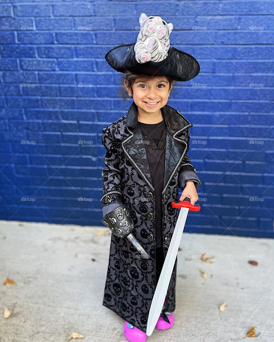 Little girl dressed as pirate, Captain Hook, family pirate costumes, trick or treating for Halloween, little girl in a pirate costume 