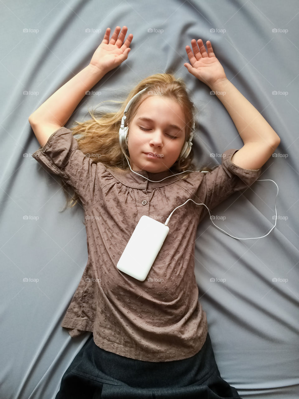 It sounds like a dream. Young girl lying on the bed and dreaming about something with closed eyes