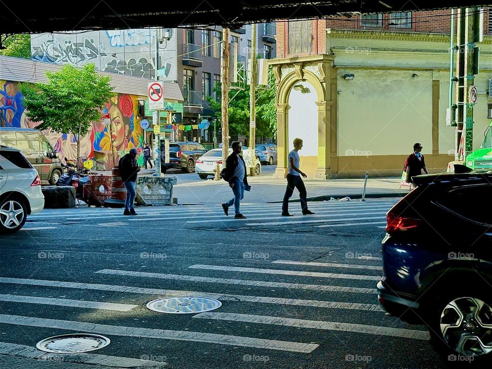 This is the intersection of “Broadway”, “Myrtle Avenue” and “Jefferson Street” on the left in “Bushwick”, Brooklyn beneath the MTA “M” train overpass. 2024. Hypnotic Productions