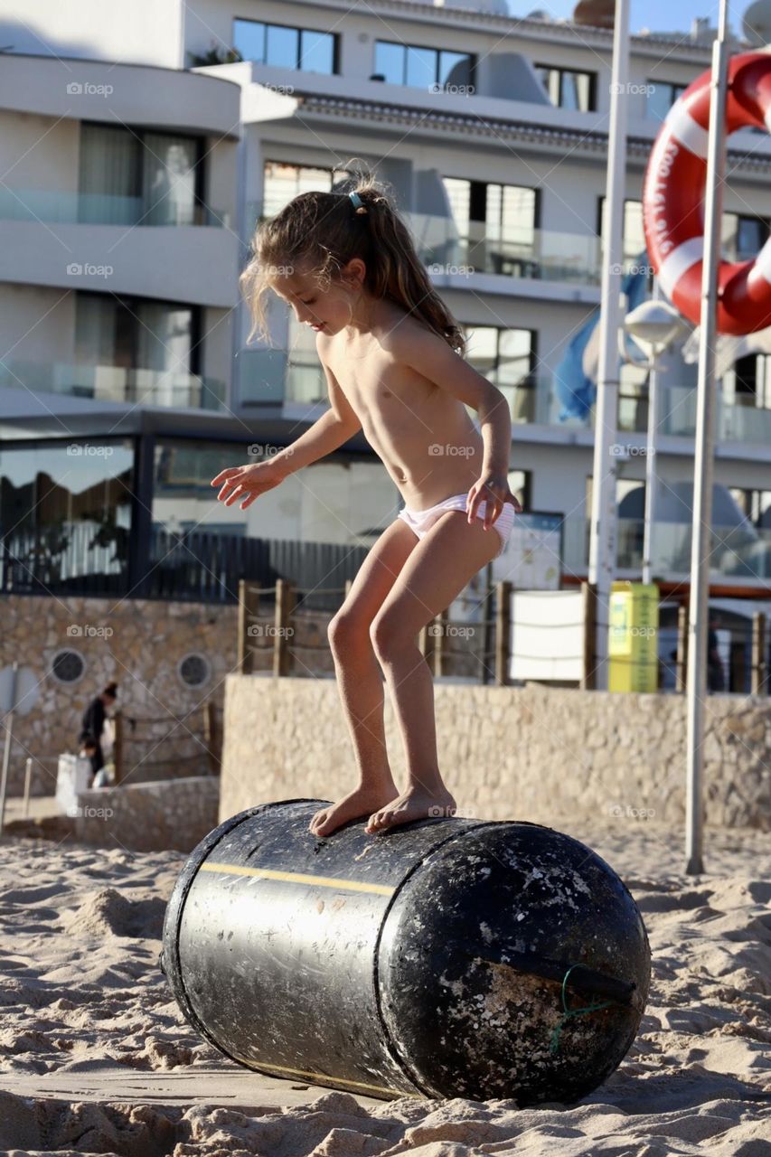 Stunts on the beach with empty barrel 