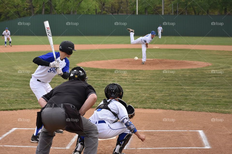 View of high school pitcher and batter during a game. 