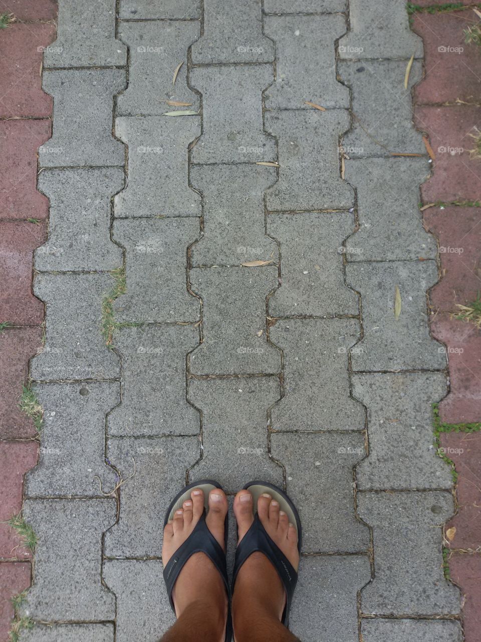 Man's feet on the beach path