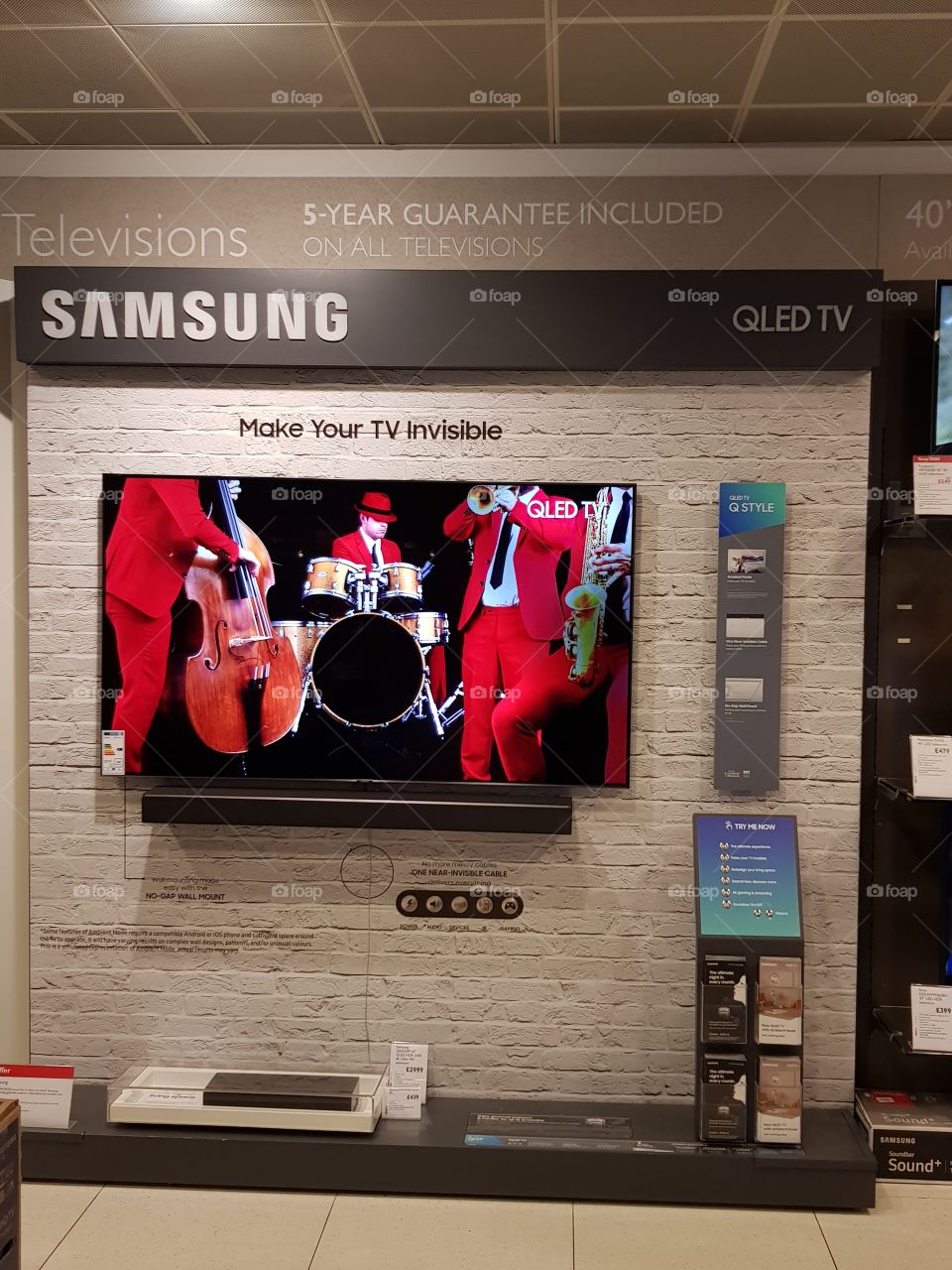 Samsung QLED ambient mode television wall mounted televisions 4K Ultra High Definition TV with soundbar at Peter Jones department store Sloane square Chelsea Kings road London