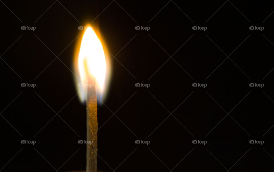 Burning match on a black background