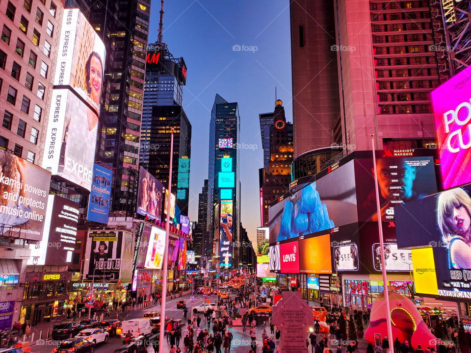 Times Square in New York City pulses with light, sound and throngs of people