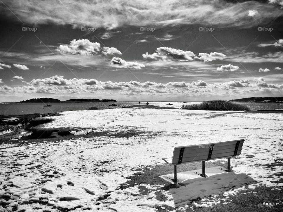 Snow covered bench during winter