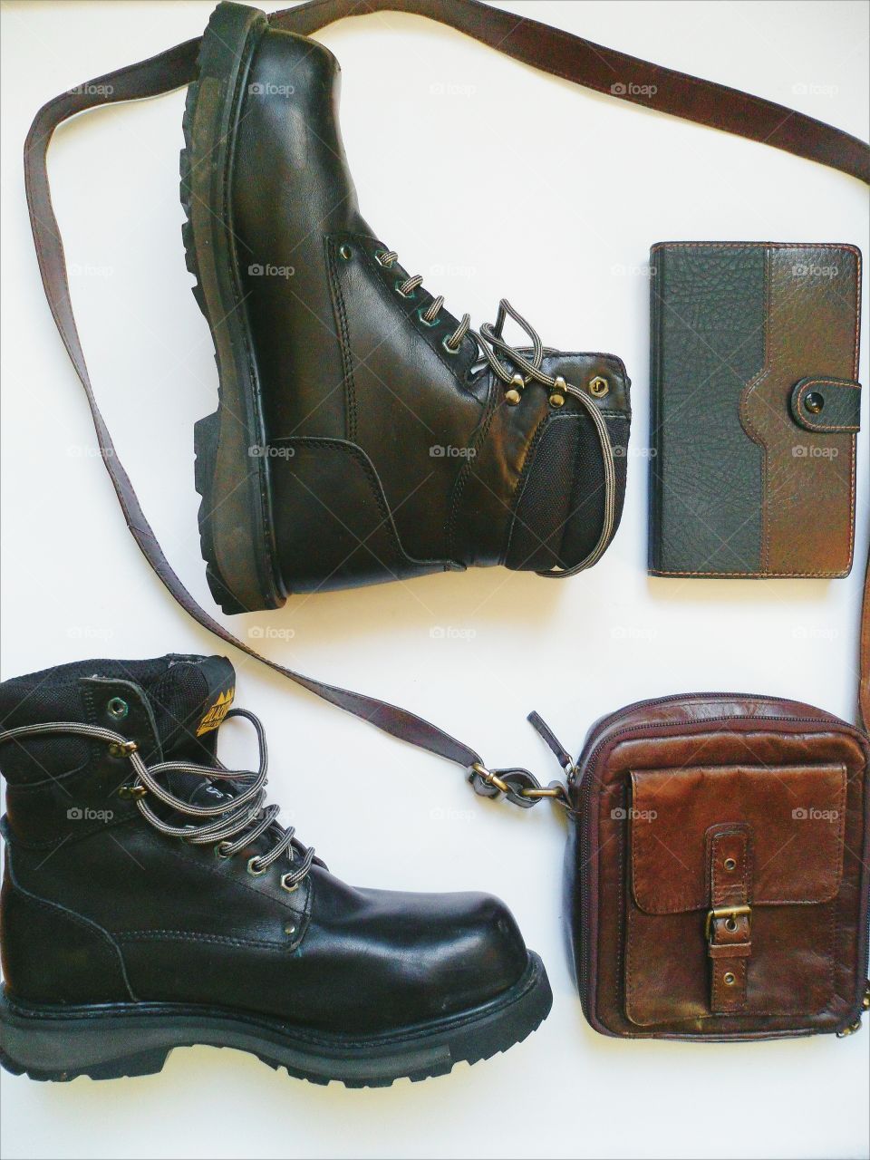 black leather men's shoes, leather bag and a notebook on a white background