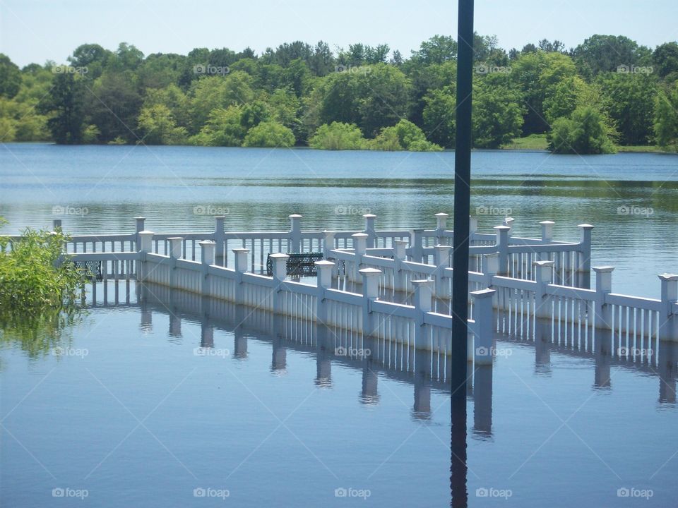 Submerged dock peeking out from a flooded lake.